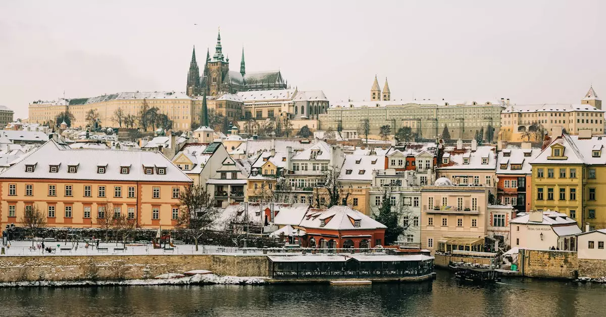 Picturesque winter scene of Prague Castle and Vltava River showcasing historic architecture under snow.