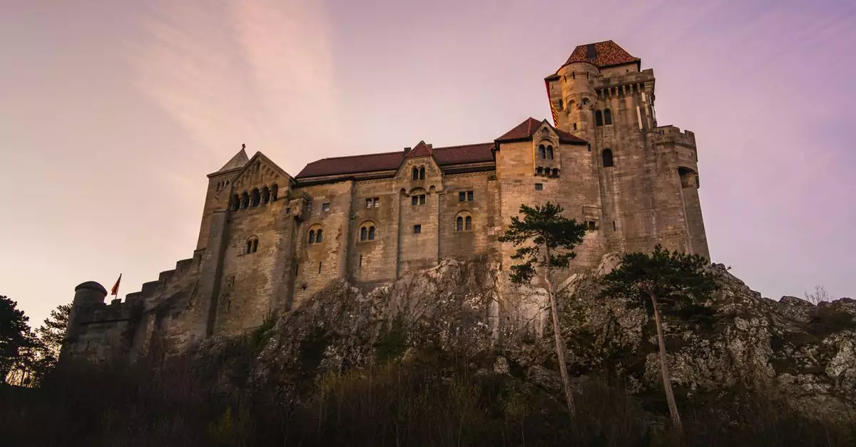 Majestic view of Liechtenstein Castle in Austria during a picturesque sunset.