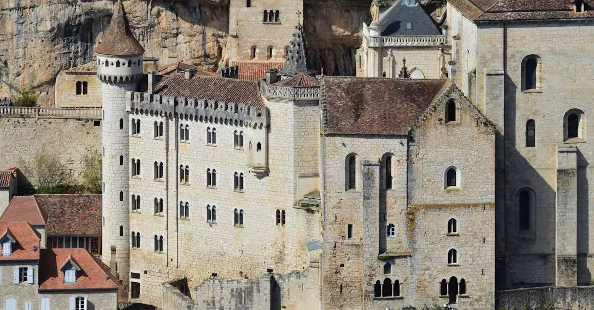 A detailed view of the medieval architecture in Rocamadour, France, set against a rocky cliff.