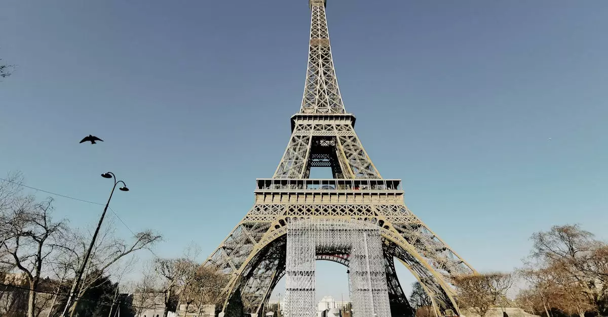 A stunning front view of the iconic Eiffel Tower in Paris with clear blue skies.