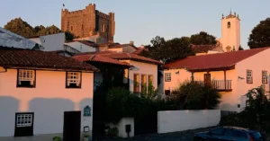 Scenic view of Bragança Castle and traditional houses at sunset, highlighting Portuguese architecture.