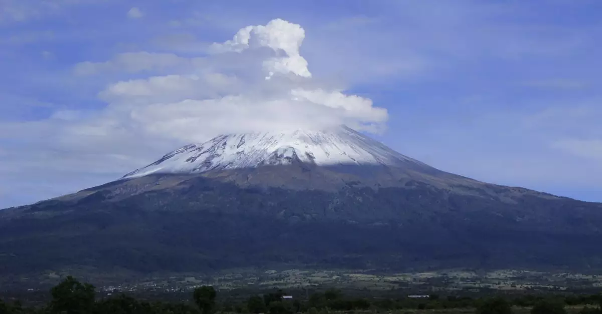 A breathtaking image of Popocatépetl Volcano with a dramatic cloudy sky backdrop.