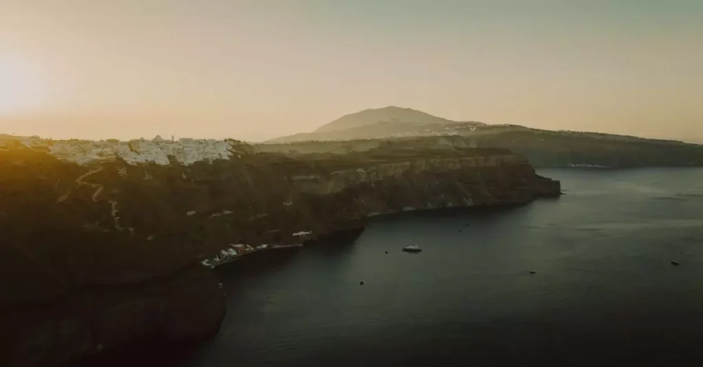 Best Volcanic Landscapes in South America 2 Capture of Thera's dramatic cliffs in Santorini, Greece, at sunset. A tranquil sea view.