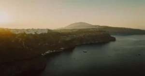 Capture of Thera's dramatic cliffs in Santorini, Greece, at sunset. A tranquil sea view.