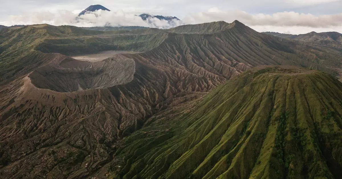 A stunning aerial view of Mount Bromo and its surrounding volcanic landscape on a cloudy day.