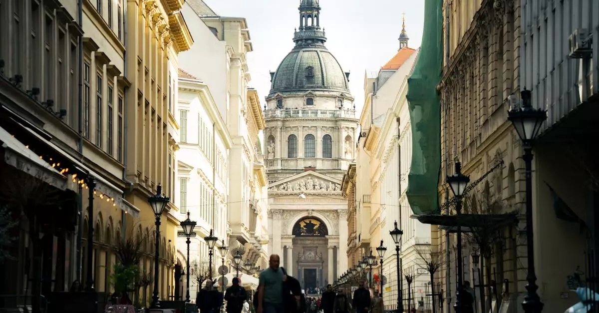 View of Saint Stephen's Basilica with pedestrians on a bustling street in Budapest.