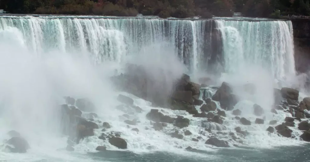 Best Waterfalls World: 2026 Guide to Top Falls 2 Captivating image of Niagara Falls' powerful cascade during autumn with mist rising.