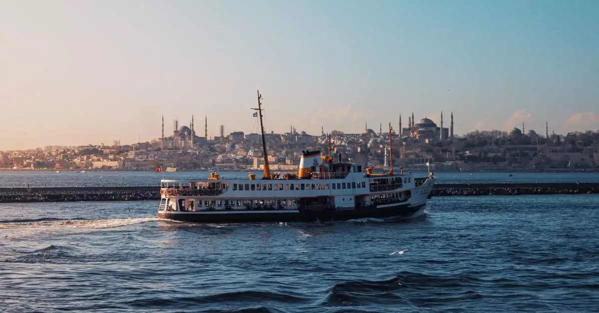 Ferry boat sailing across the Bosphorus with iconic Istanbul skyline at sunset.