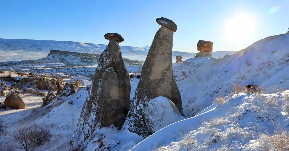 Stunning winter view of snow-covered fairy chimneys in Cappadocia, Turkey.