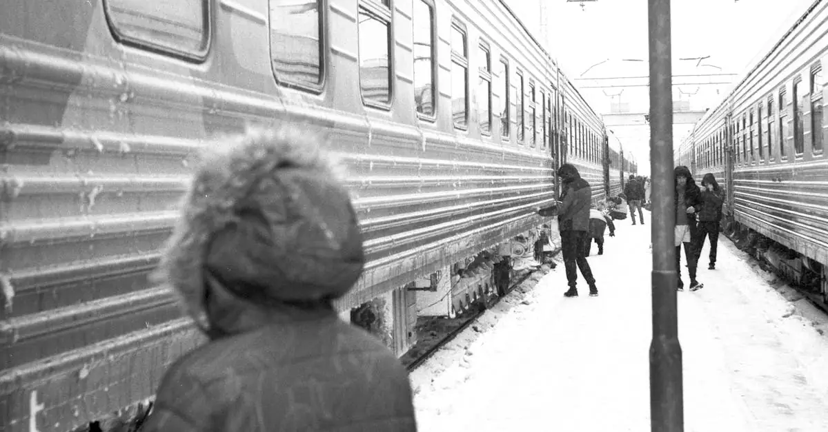 Black and white image of people at a snowy train station in winter.