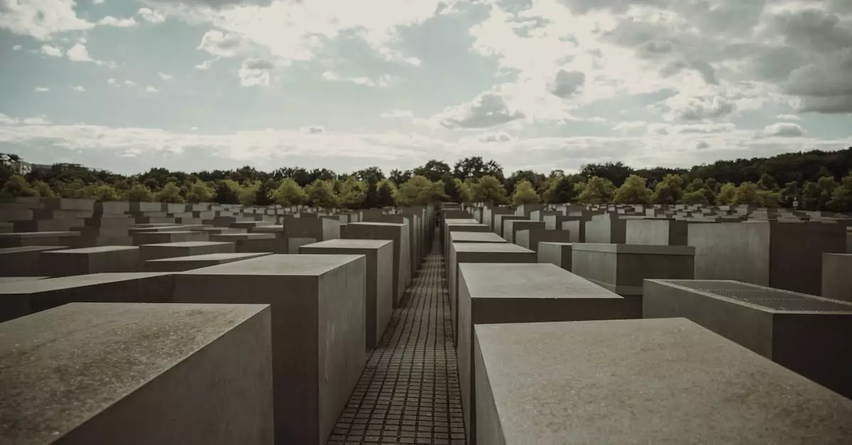 A view of the Holocaust Memorial in Berlin under a dramatic and cloudy sky.