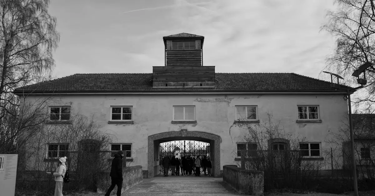 A solemn view of Dachau's entrance building in a black and white photograph, capturing its historical significance.
