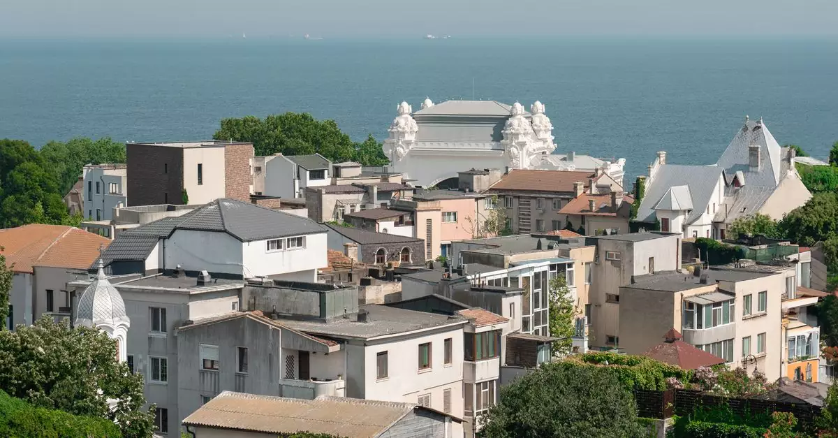 A picturesque view of a coastal town with Mediterranean-style architecture by the sea.