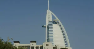 Iconic Burj Al Arab tower standing tall in Dubai under a clear blue sky.