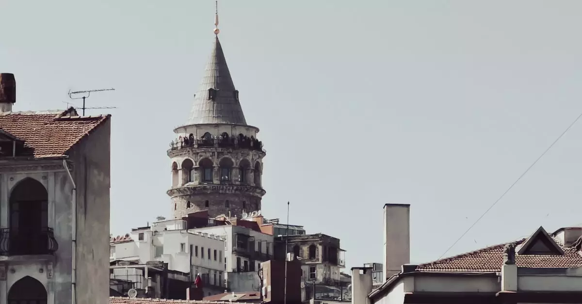 View of the historic Galata Tower rising above buildings in Istanbul, Turkey.