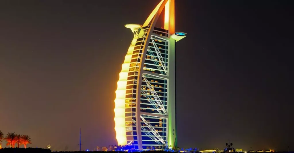 Iconic Burj Al Arab Jumeirah Hotel illuminated at night in Dubai.