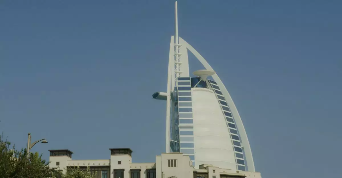 Iconic Burj Al Arab tower standing tall in Dubai under a clear blue sky.
