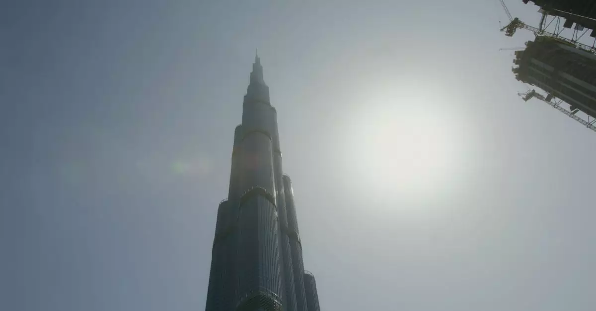 A striking low angle shot of the Burj Khalifa towering under the bright sun in Dubai.