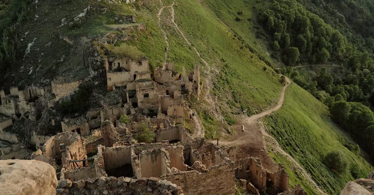 Explore the haunting ancient ruins of Gamsutl village nestled on a lush mountainside in Dagestan.