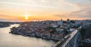 Captivating sunset over Porto with Dom Luís I Bridge and the Douro River in view.