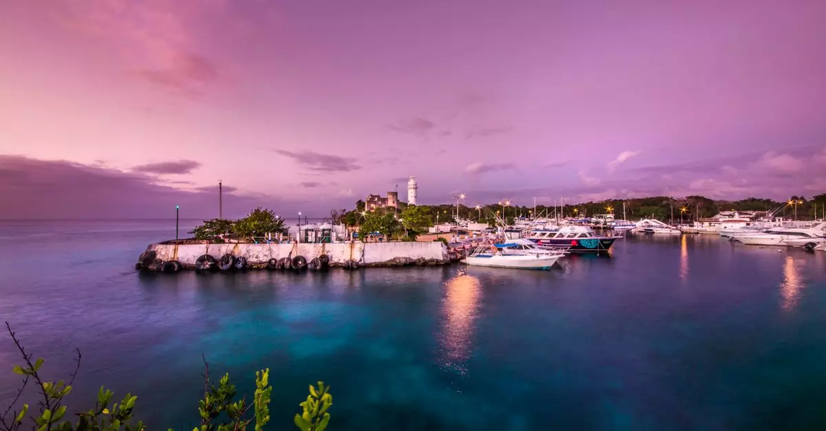 Vibrant and serene harbor in San Miguel de Cozumel, Mexico during sunset with boats moored peacefully.