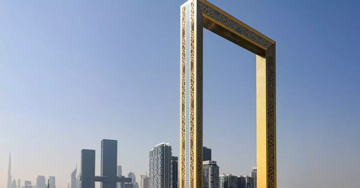 The iconic Dubai Frame with city skyscrapers in the background under a clear sky.