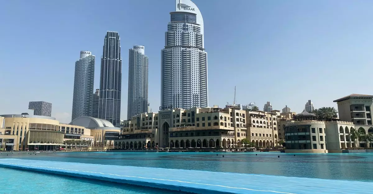 Stunning view of Dubai's skyscrapers with a luxurious pool in the foreground.