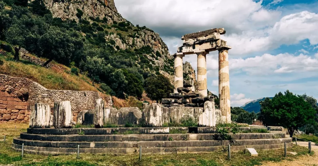 Delphi, Greece Travel Guide: Ancient Oracle & Views 2 Explore the ancient temple ruins of Delphi set against a mountainous backdrop in Greece.