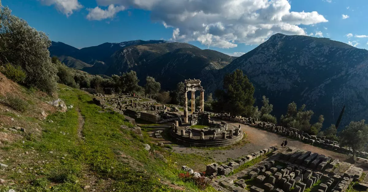Explore the ancient ruins of Delphi, Greece, set against a stunning mountain landscape under a vibrant blue sky.