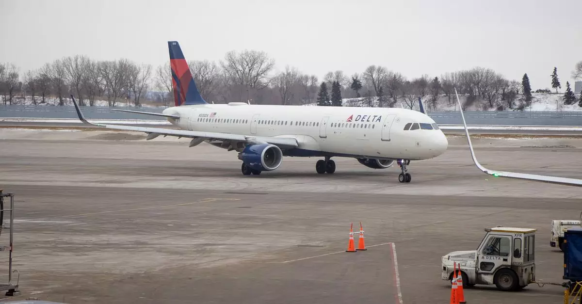 Delta airplane preparing for departure at a snowy Minnesota airport.
