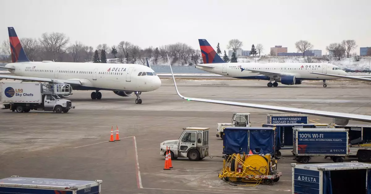 Delta airplanes on the snowy tarmac surrounded by service vehicles at a busy airport.
