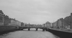 Black and white photo of Grattan Bridge over River Liffey in Dublin, Ireland.