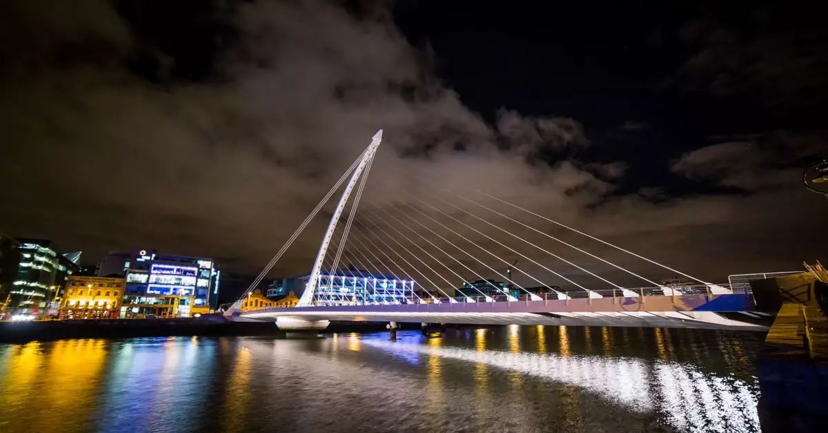Captivating night scene of the illuminated Samuel Beckett Bridge in Dublin, Ireland.
