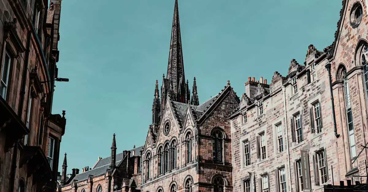 Gothic architecture in Edinburgh featuring tall spires and historic facades under a clear sky.
