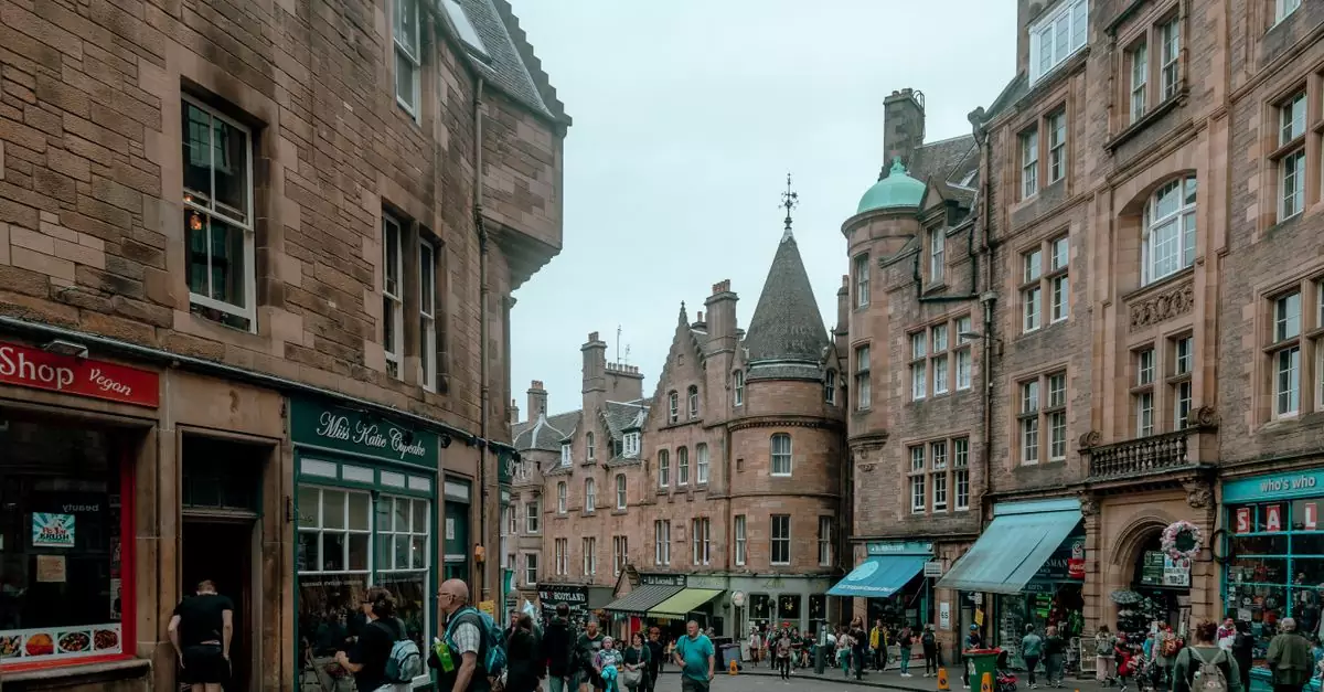 Bustling street scene in Old Town Edinburgh with historic architecture and pedestrians.