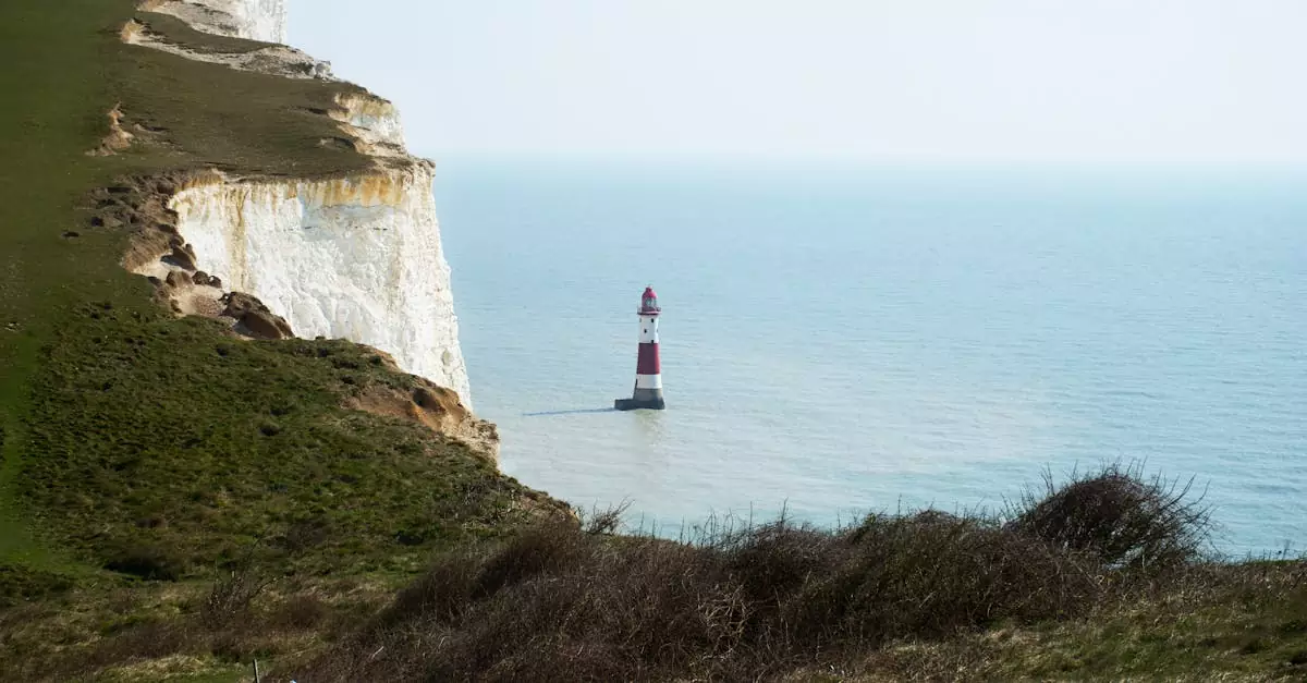 Stunning view of the iconic Beachy Head Lighthouse beside towering white cliffs near Eastbourne, UK.