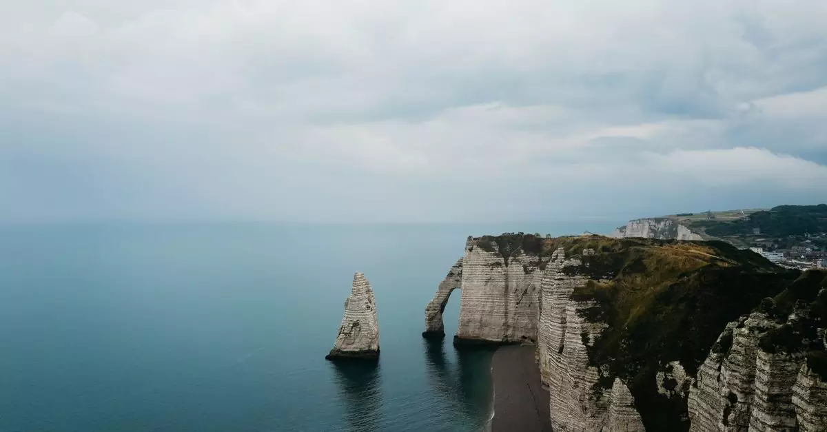 Stunning aerial view of the iconic limestone cliffs and natural arches at Étretat, Normandy.