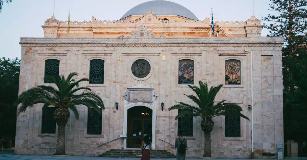 A beautiful historic church with a classic facade and palm trees at sunset.