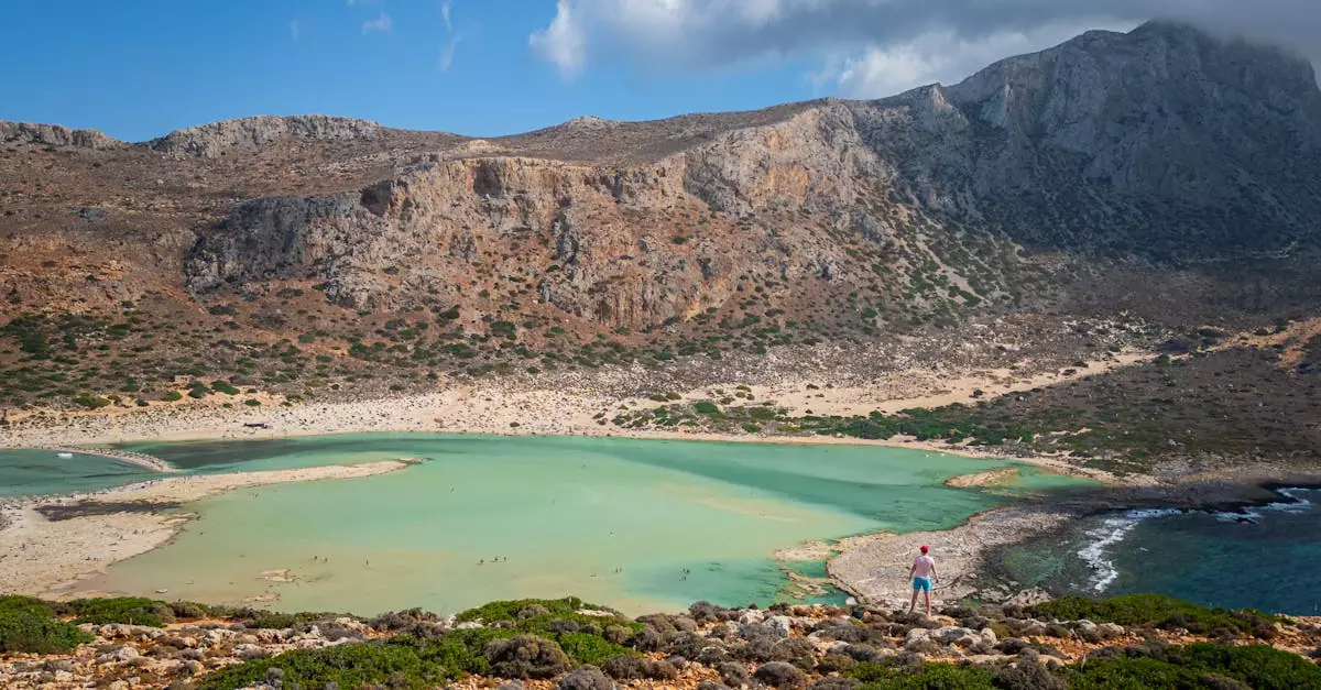 A breathtaking aerial view of Balos Lagoon, featuring turquoise waters and rugged mountains under a clear sky.