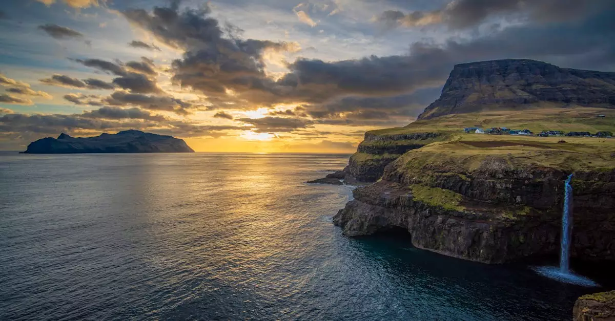 Breathtaking view of Mulafossur Waterfall with a sunset backdrop in the Faroe Islands.