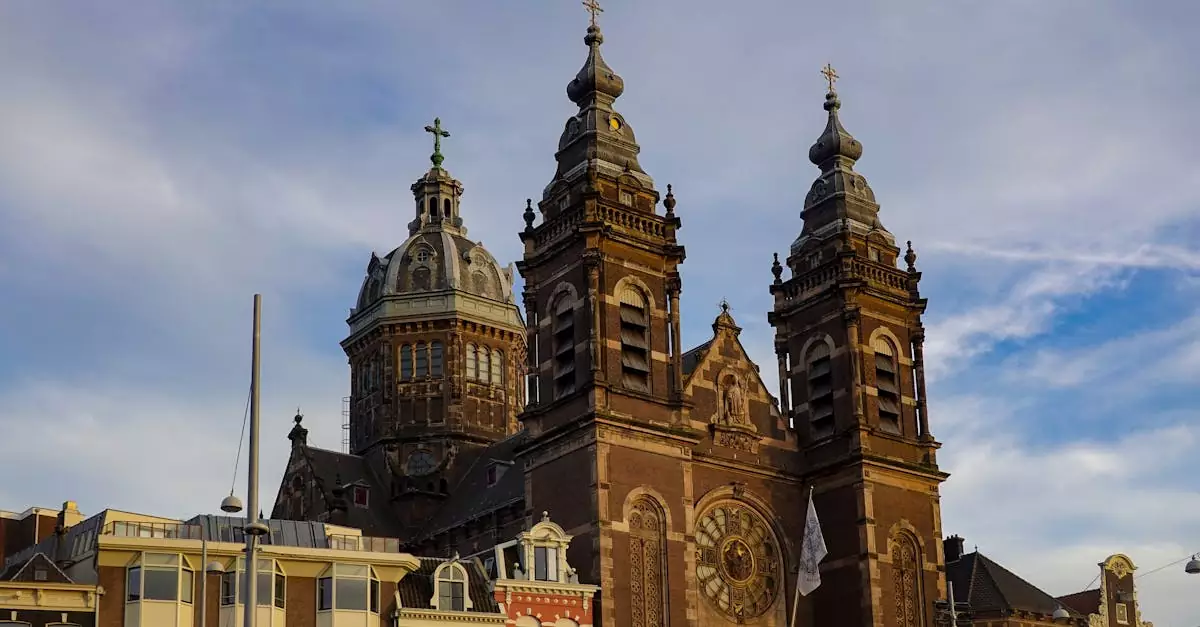 Beautiful architectural landmark in Amsterdam showcasing the Basilica of Saint Nicholas against a blue sky.