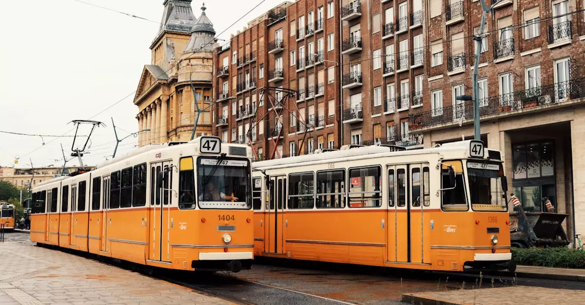 Vintage yellow trams passing by historic buildings in Budapest, Hungary.