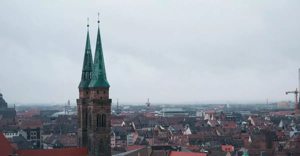 Aerial view of St. Sebaldus Church amidst the historic Nuremberg cityscape on a cloudy day.
