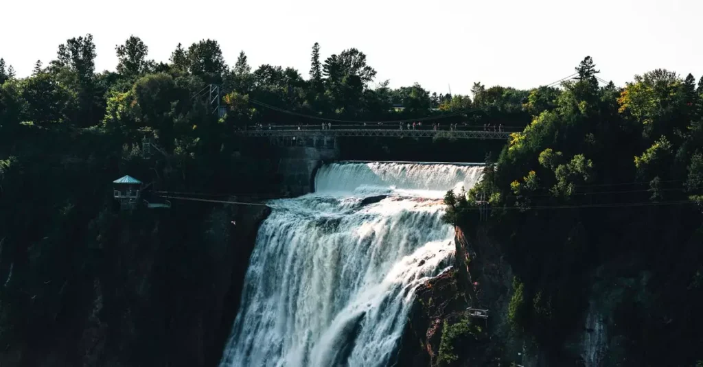 Fundy National Park Experiences: Your Ultimate Guide 2 Stunning view of Montmorency Falls in Québec surrounded by lush greenery and a pedestrian bridge.