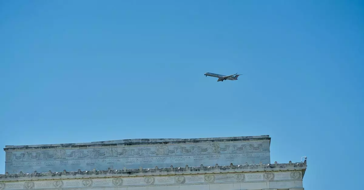 An airplane flies over the iconic Lincoln Memorial under a clear blue sky in Washington, D.C.