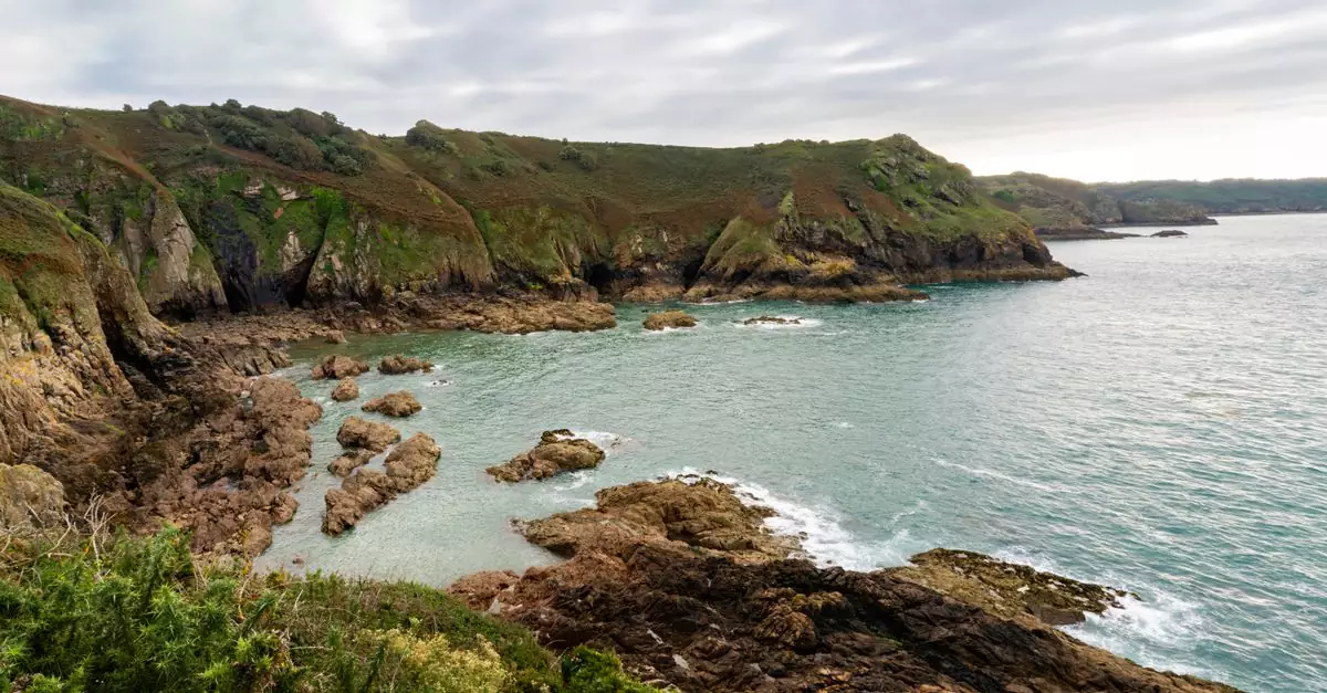 Breathtaking view of Jersey's rugged coastline with rocky cliffs and serene sea.