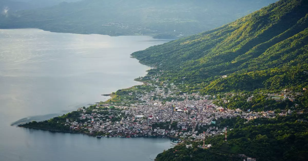 Stunning aerial shot of Lake Atitlán and a nearby town nestled among lush mountains.