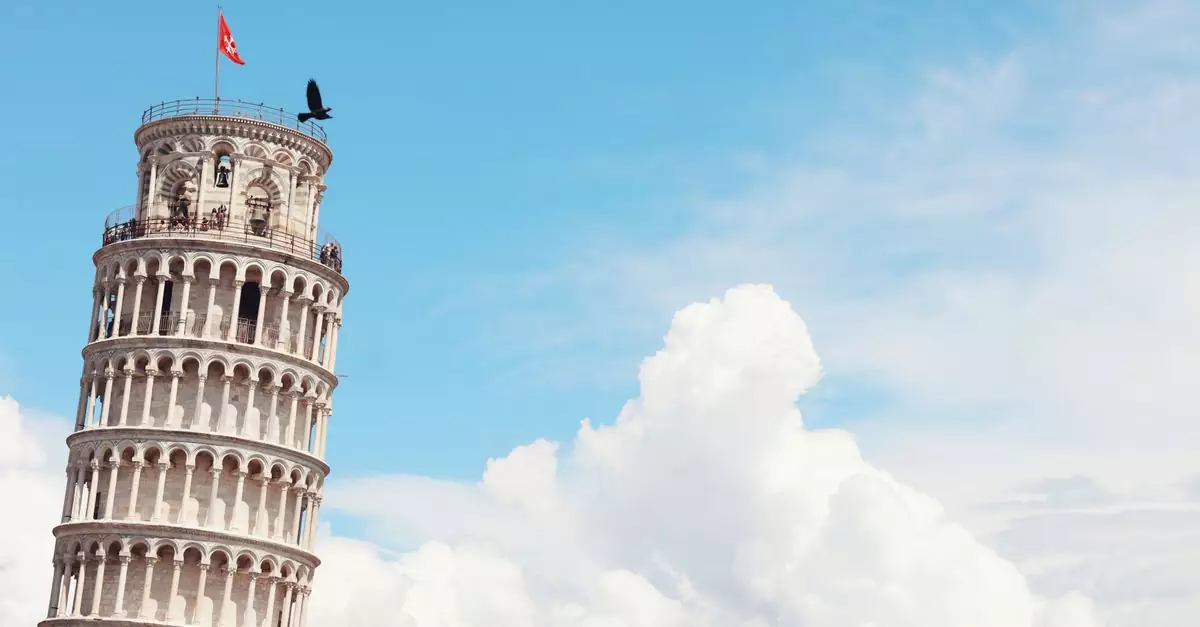 Iconic Leaning Tower of Pisa with clear sky and clouds, a must-see landmark.