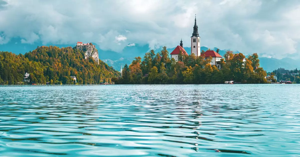 Beautiful landscape of Lake Bled with iconic church and mountain backdrop.