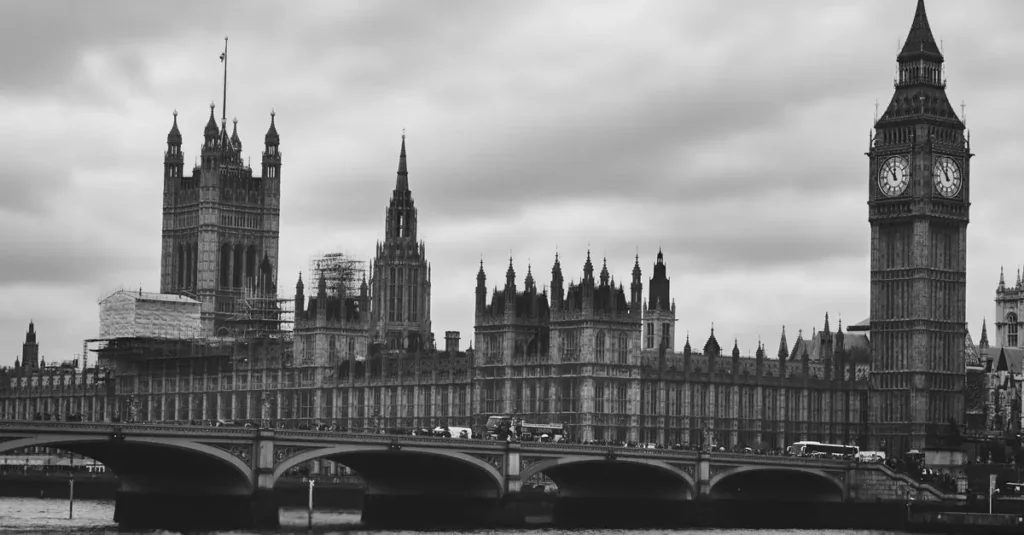 Monochrome view of Big Ben and Westminster Bridge over the Thames in London, UK.